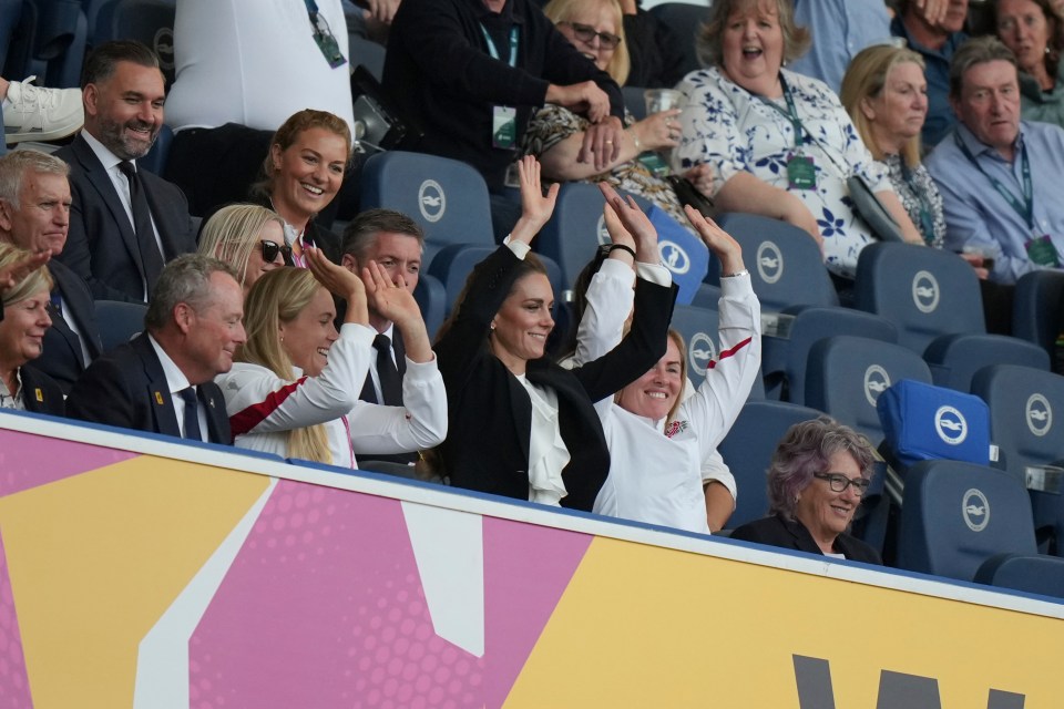 Kate, Princess of Wales, and other spectators cheering at a Women's Rugby World Cup match.