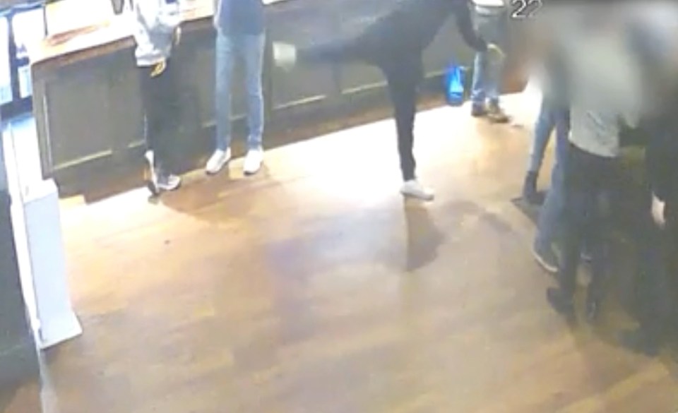 CCTV footage of a man attempting a kung fu kick and falling.