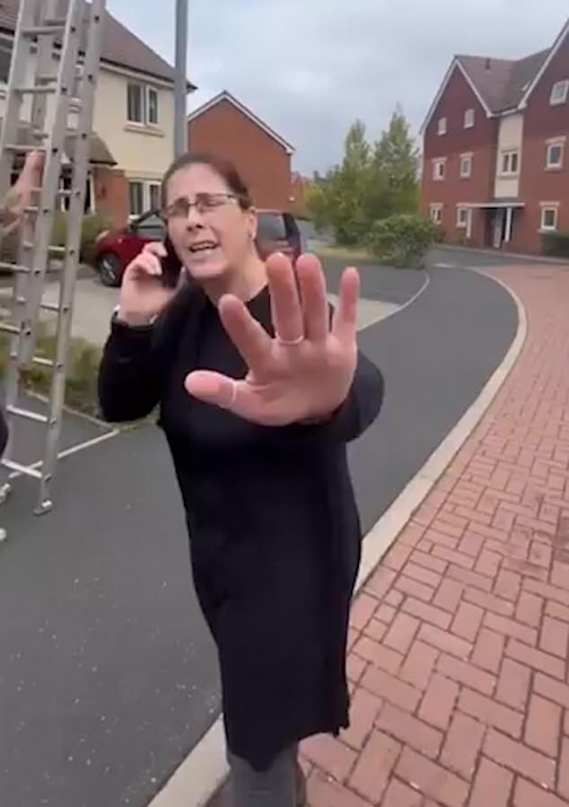 The woman was seen on the phone to police during the row, which ended when a police officer arrived at the scene