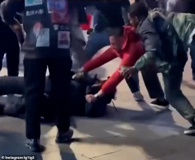 Shocking footage posted online shows a group of men pinning the alleged attacker to the ground