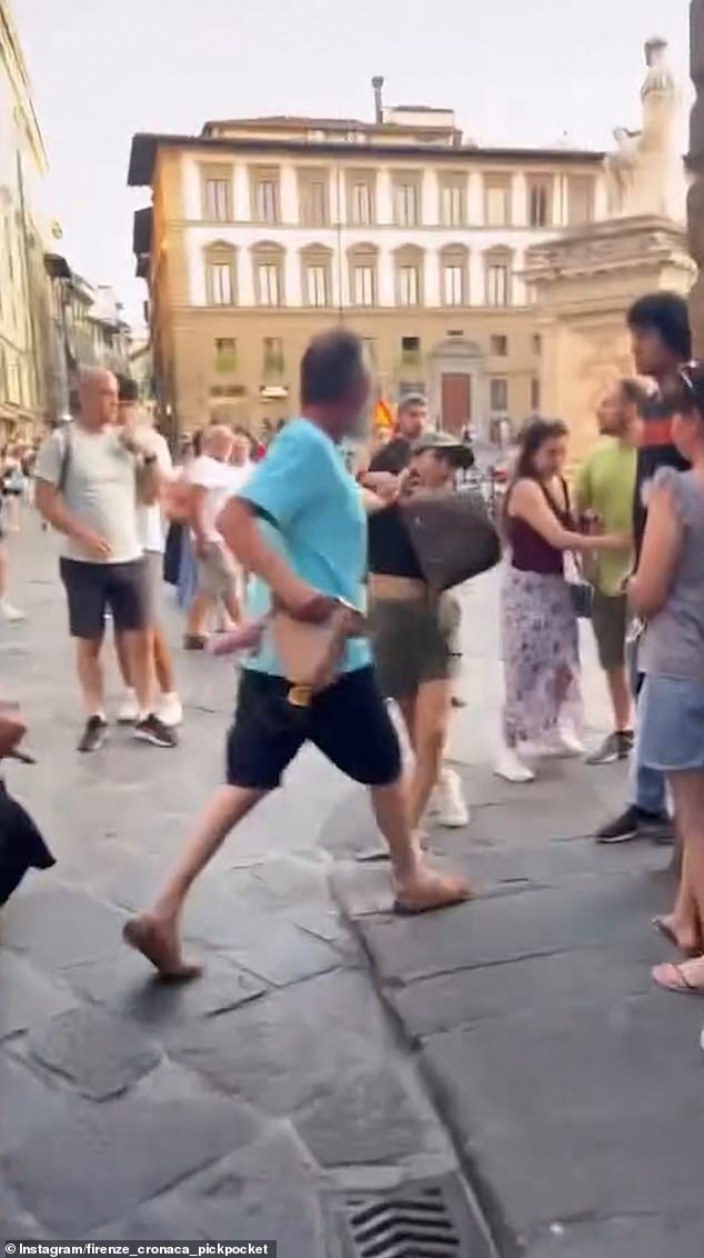 A 'pregnant' pickpocket was grabbed by the hair and prevented from running away as she tried to steal a tourist's backpack in Italy