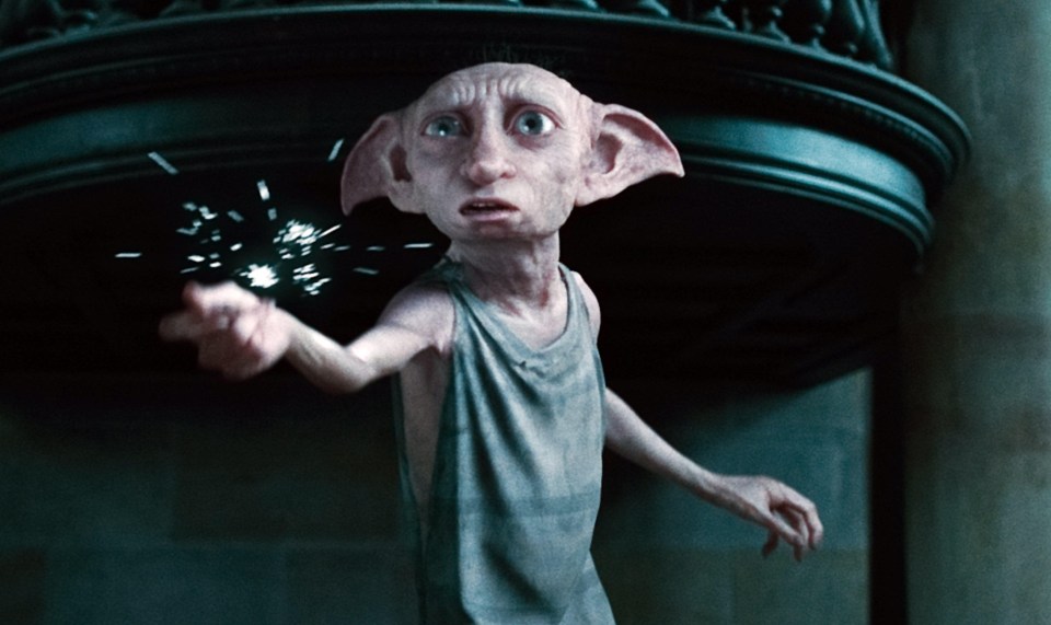 Dobby casting a spell, with sparks flying from his hand.
