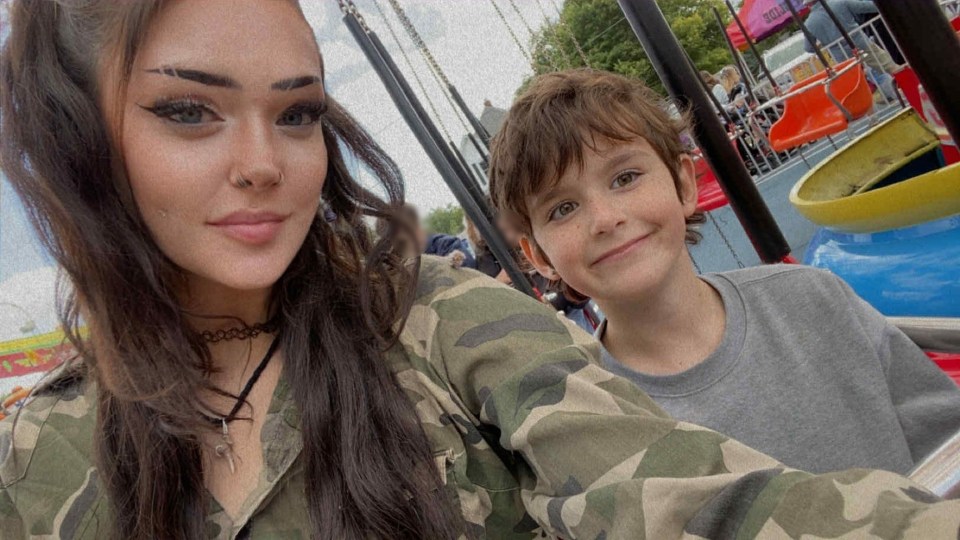 Savanah White and her son Malakye White smiling while on a swing ride at a park.