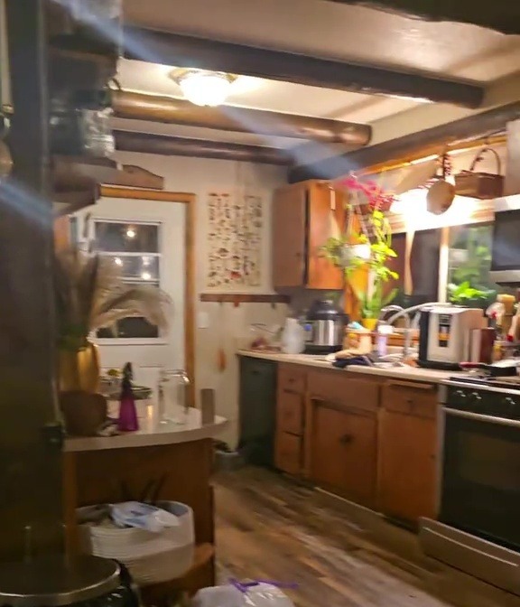 Photo of a kitchen with a hidden toy room behind the couch.
