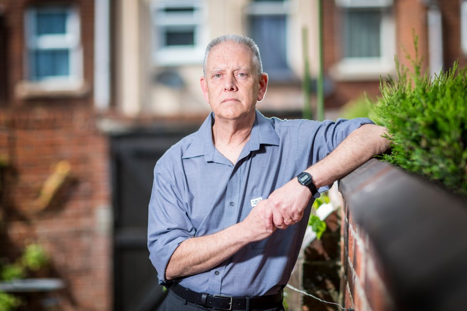 Kevin Gosden, father of missing Andrew Gosden, leaning on a brick wall.