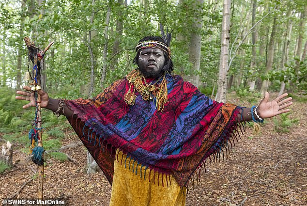 Self-styled ‘King Atehene' with his face smeared with ash from the fire and cowrie shells on his feathered headdress