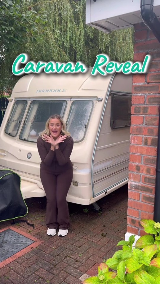 A woman in a brown tracksuit standing in front of a white caravan with the words "Caravan Reveal" overlaid on the image.