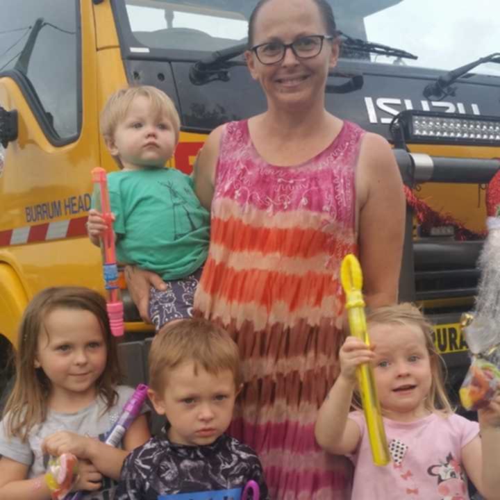 Woman with four children holding bubble wands.