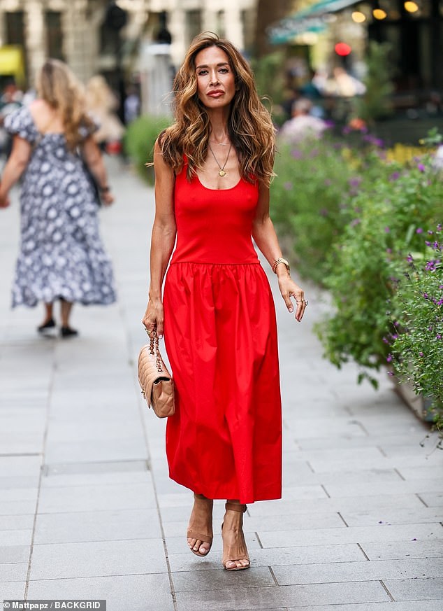 Myleene Klass turned heads in a bold red ensemble as she strut out of the Smooth Radio studios in London on Saturday