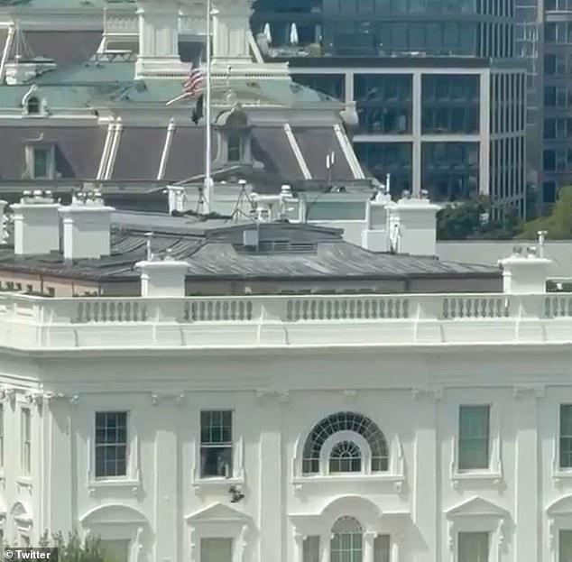 The video appears to show an unknown individual throwing an object out of the top window of the White House