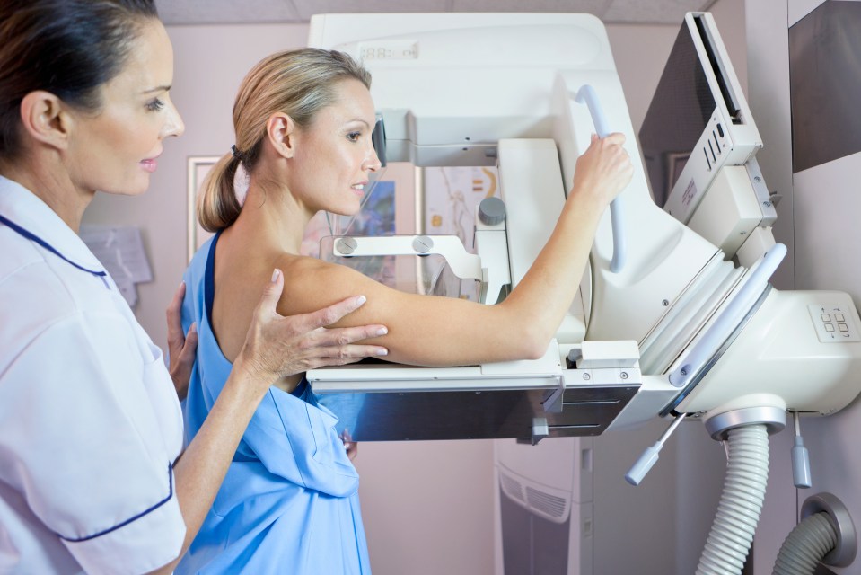 Nurse assisting patient during mammogram.