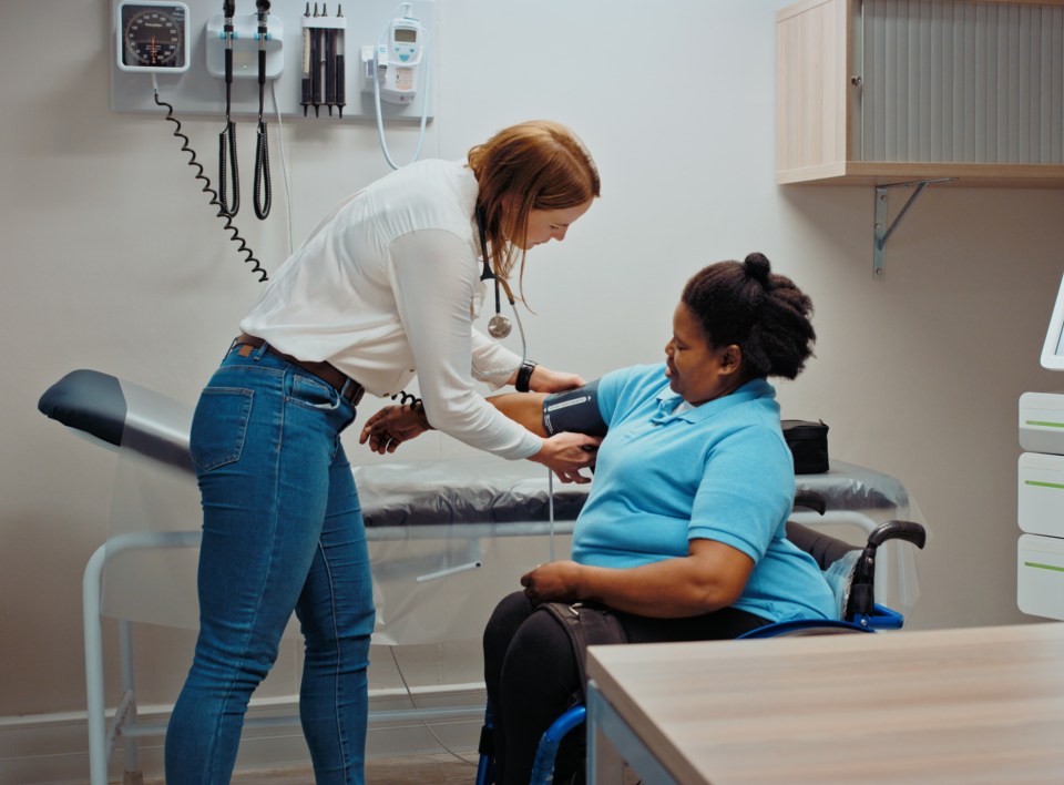 Doctor taking a patient's blood pressure.