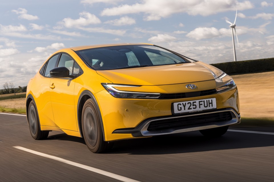 Yellow car driving on a road.