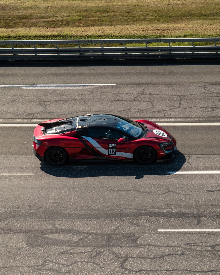 A red Yangwang U9 Xtreme production car, numbered 02, on a track test.