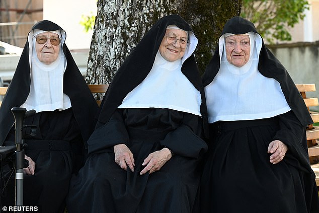 Nuns Regina, 86, Rita, 81, and Bernadette, 88, sit on a bench as they occupy their old Goldenstein convent in Goldenstein castle, near Salzburg, and refuse to move back to their retirement home, in Elsbethen, Austria, September 12, 2025