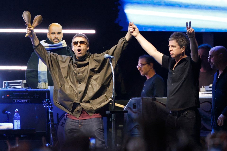 Liam and Noel Gallagher of Oasis performing on stage at Soldier Field in Chicago.