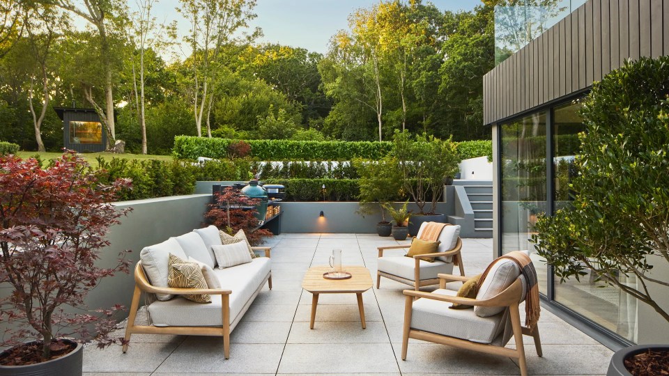 Outdoor patio furniture set in a garden.