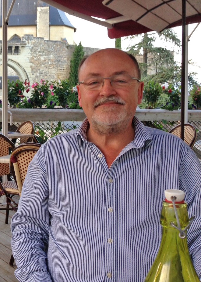Steve Holbrook-Sishton, father of three, seated outdoors.
