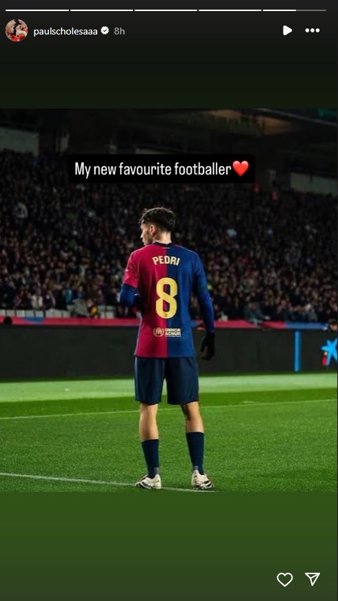 Pedri in a Barcelona kit with the number 8 on his back, facing away from the camera on a soccer field.