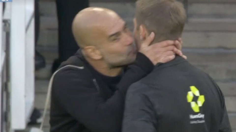 Pep Guardiola appears to kiss a referee on the cheek.
