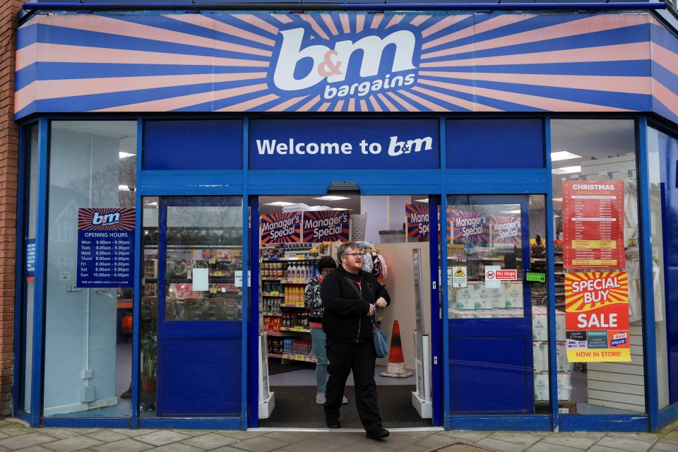 Shoppers walk past the entrance of a B&M store.