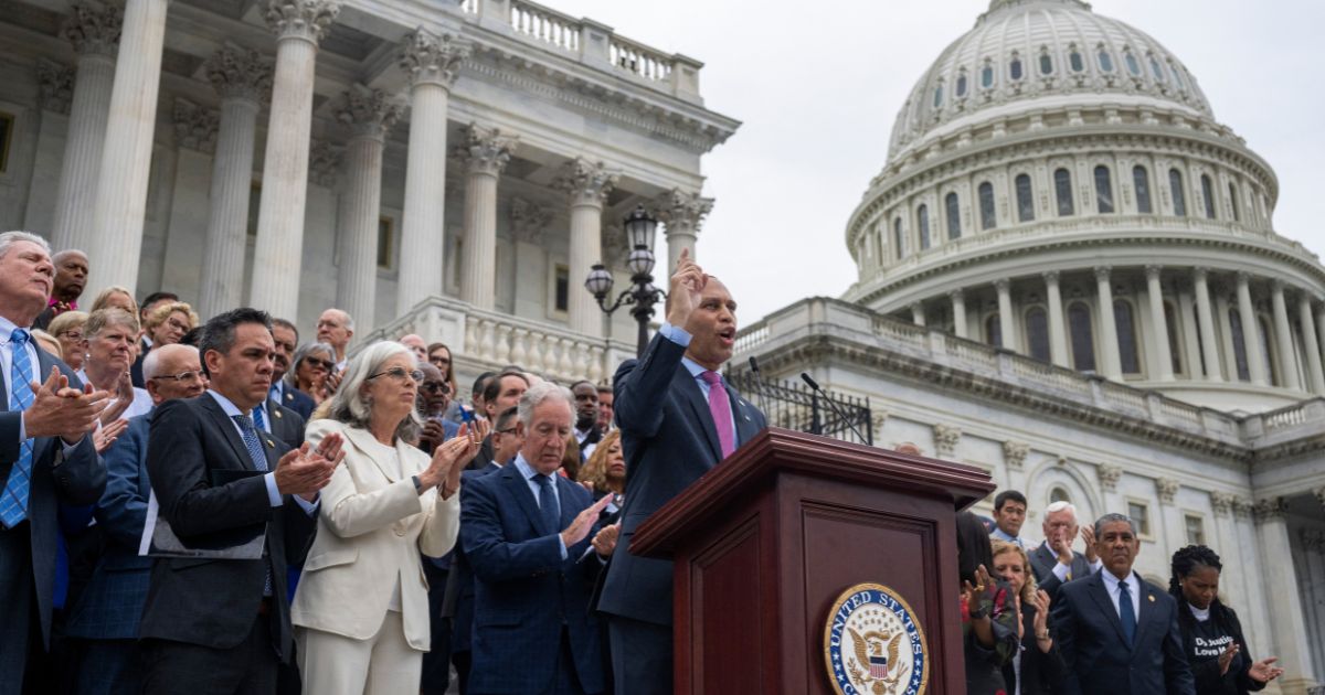 House Minority Leader Hakeem Jeffries, surrounded by House Democrats, speaks on the steps of the U.S. Capitol in Washington, D.C., on July 1.