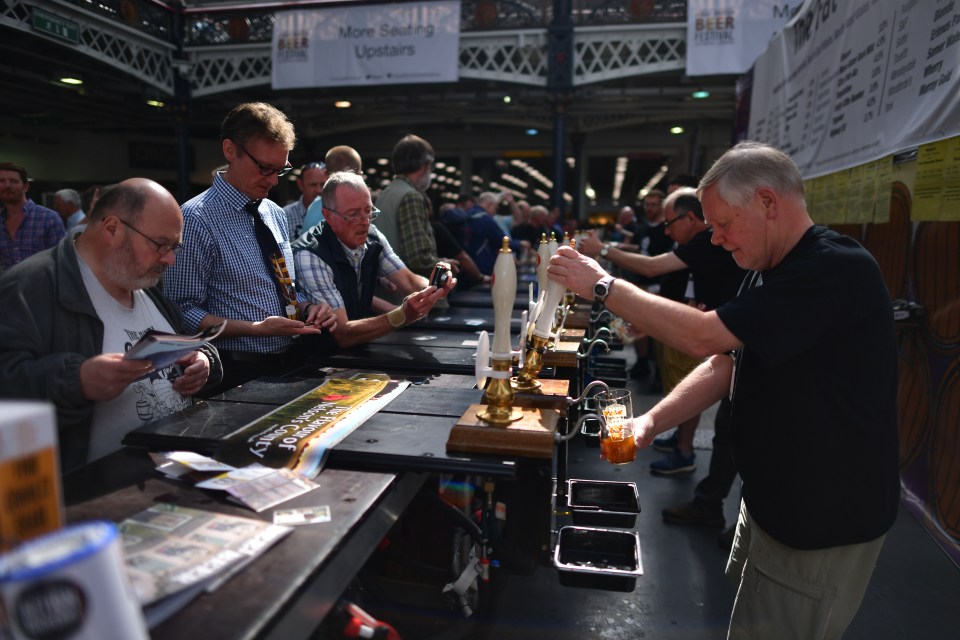 Bar staff pouring beer at a beer festival.