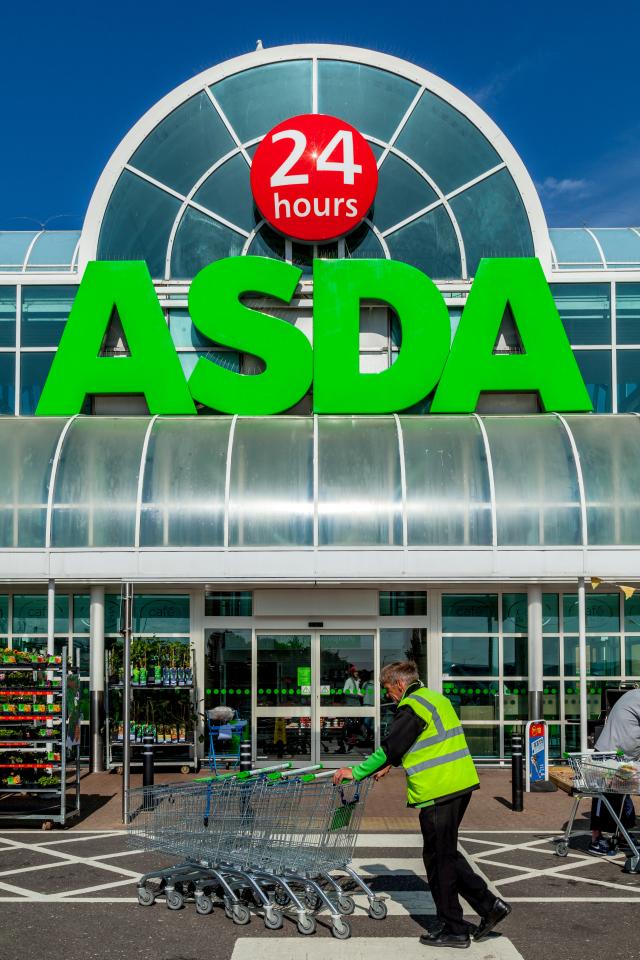 Man in a high-visibility vest pushing shopping trolleys in front of an Asda supermarket.