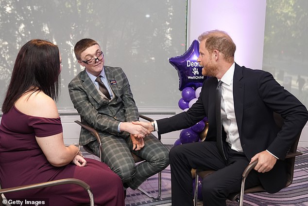 Prince Harry spoke about the 'challenging' relationship between siblings when chatting with WellChild awards winner Declan Bitmead (centre) at London's Royal Lancaster Hotel last night