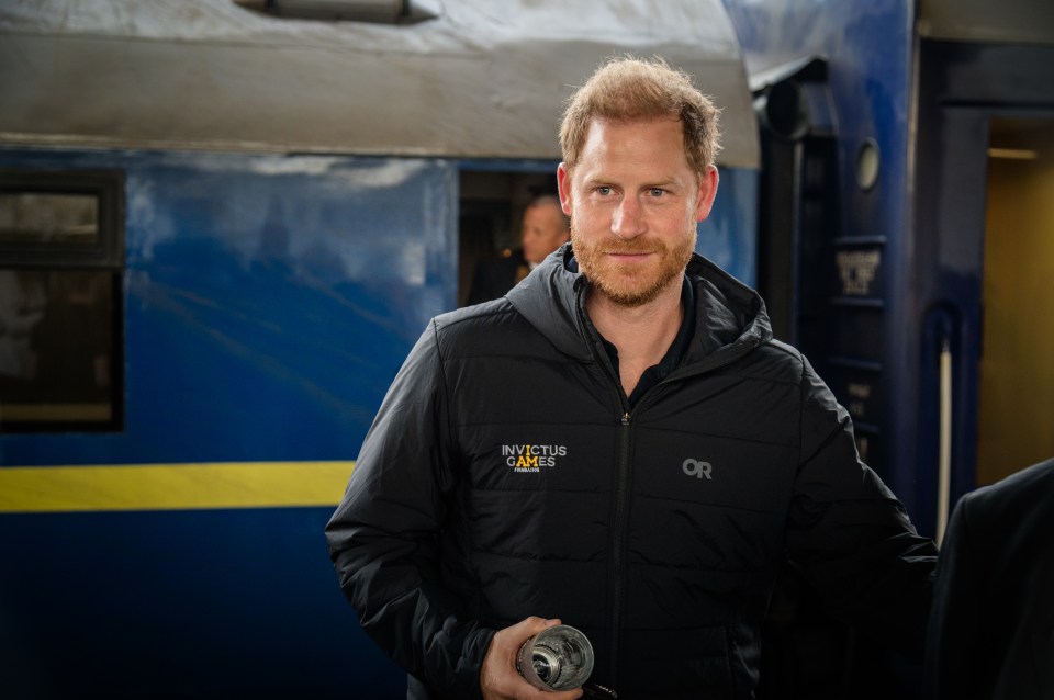 Prince Harry at a train station in Kyiv, Ukraine, wearing an Invictus Games Foundation jacket.