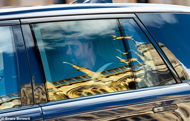 Prince Harry visited the late Queen Elizabeth II's grave moments after touching down as he returned to Britain for the first time in five months today. He is pictured arriving at Windsor Castle