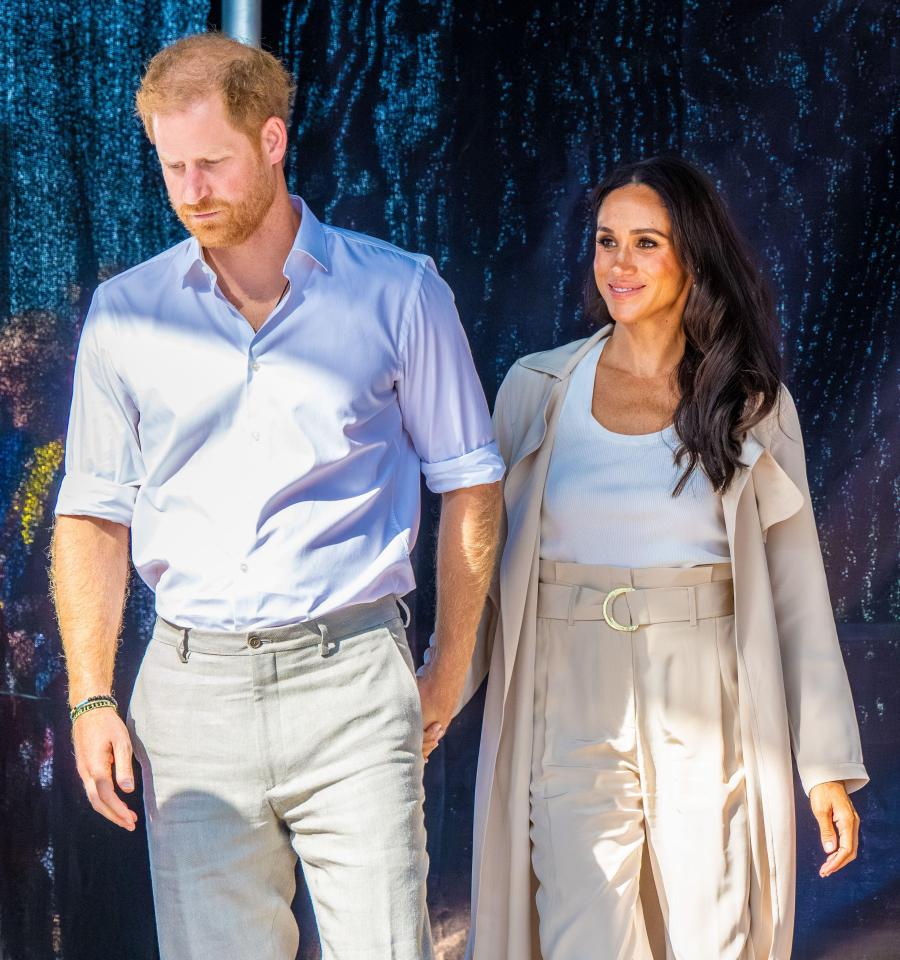 Prince Harry and Meghan Markle holding hands.