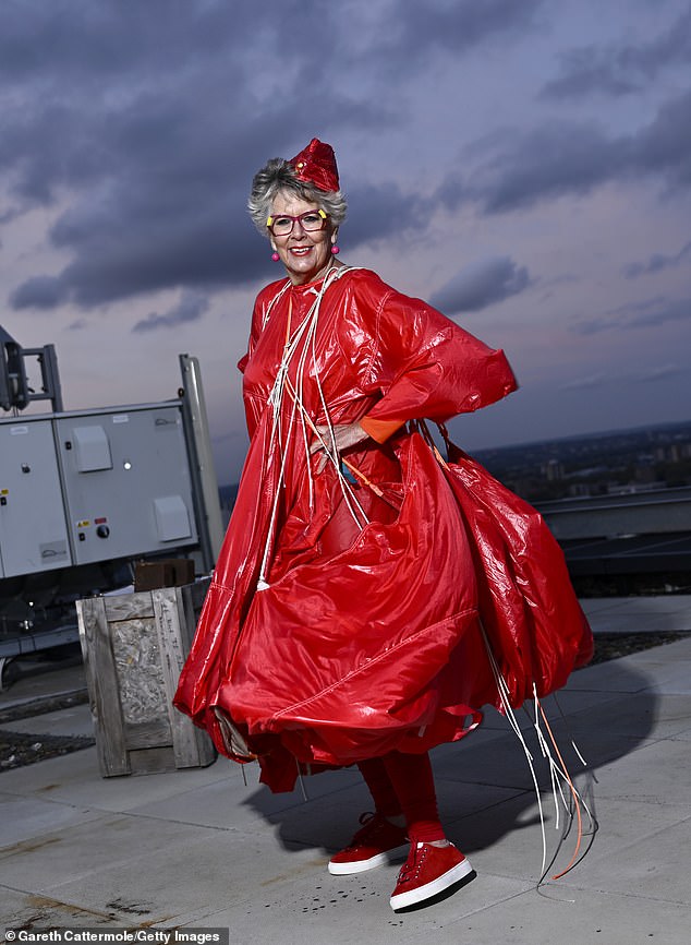 Prue's garment featured a dramatic hemline while Prue added to her look with a pair of red and white trainersThe TV star complimented her look with a small red hat and accessorised with fuchsia earrings.