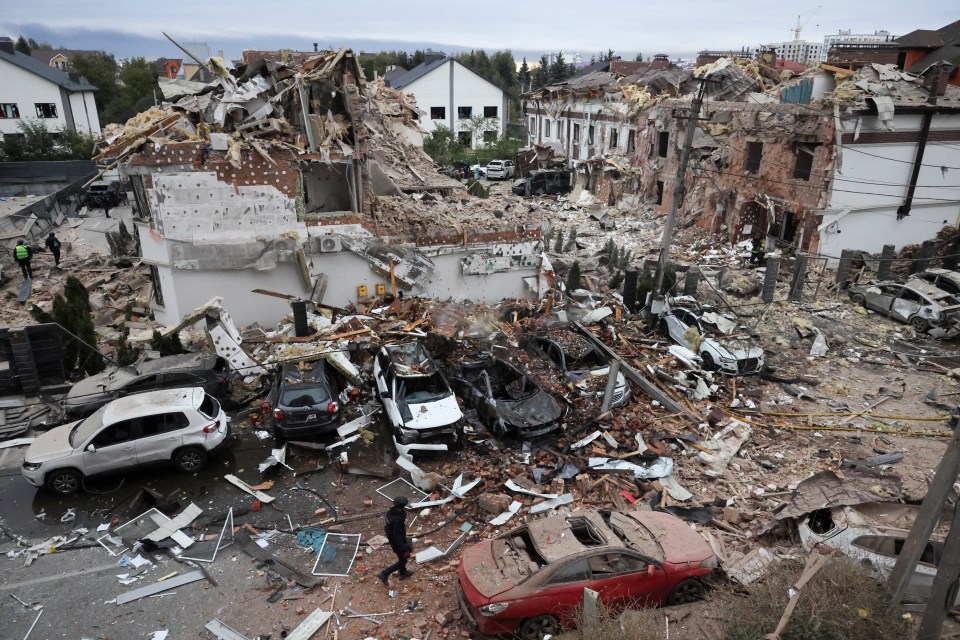 Emergency workers operate at an impact site in a residential neighborhood after drone and missile attacks in Kyiv, Ukraine.