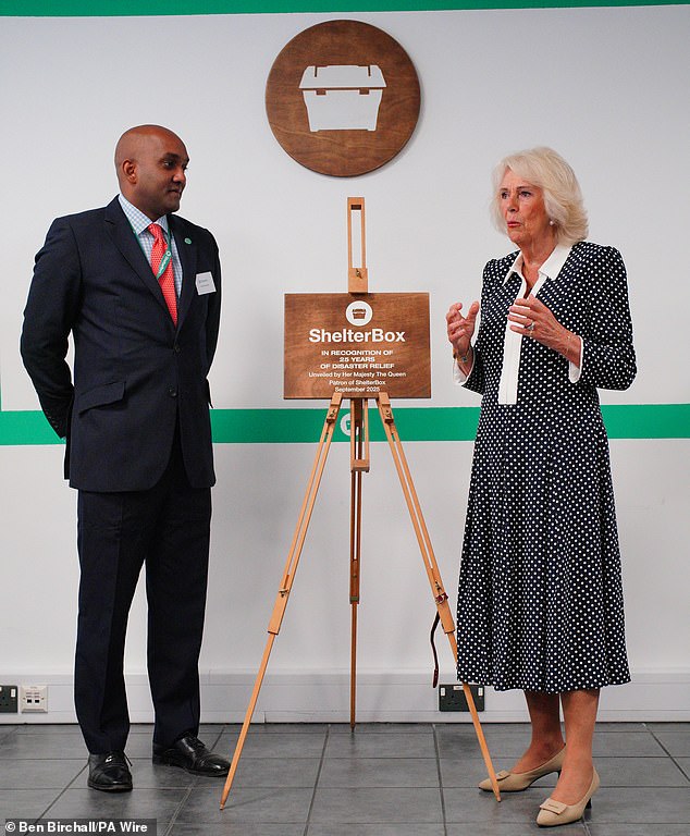 Camilla unveils a plaque alongside Chief Executive Officer of ShelterBox, Sanj Srikanthan (left), to commemorate her visit to the headquarters