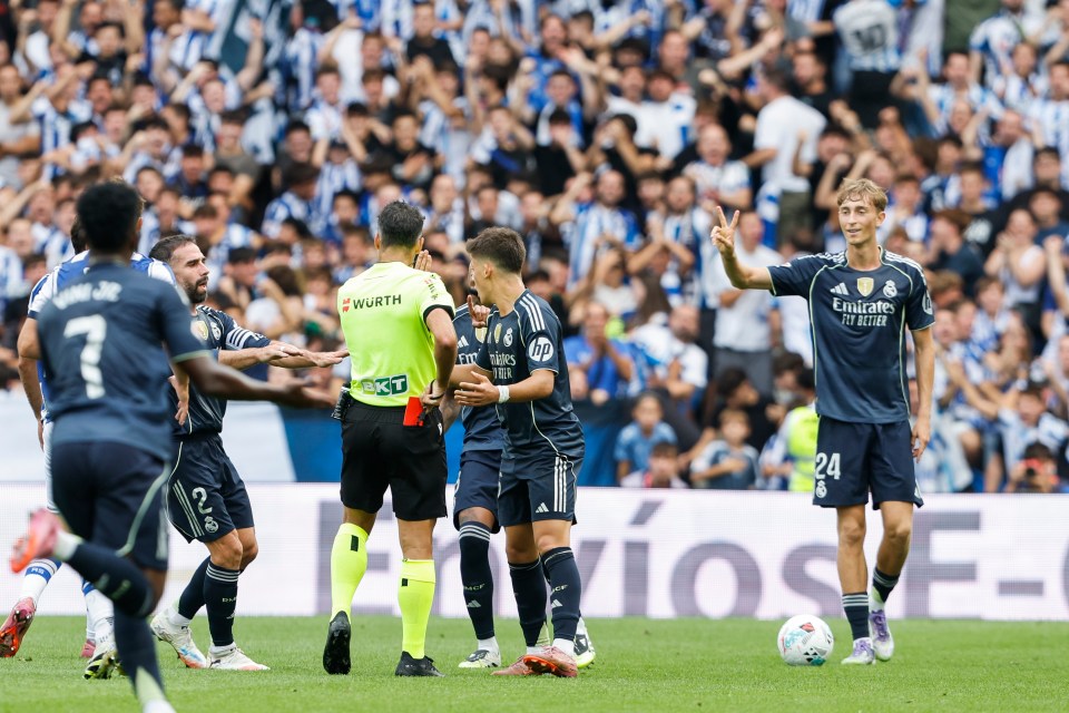 Real Madrid player receives red card from referee.
