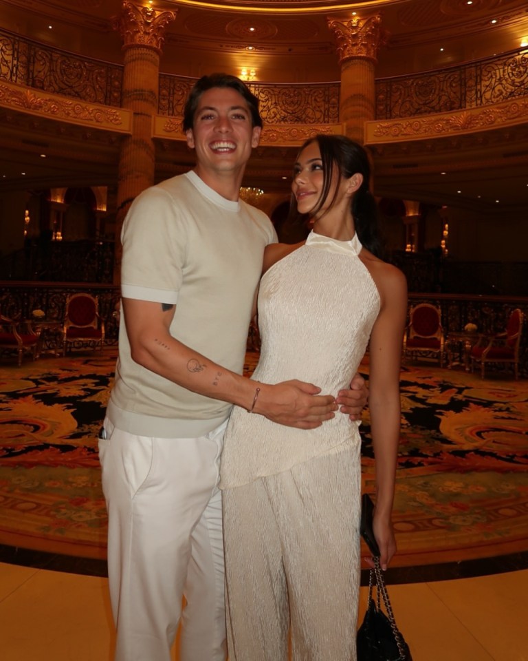 Alice Yaxley and Sam Vanderpump posing together, with Sam's arm around Alice's waist.