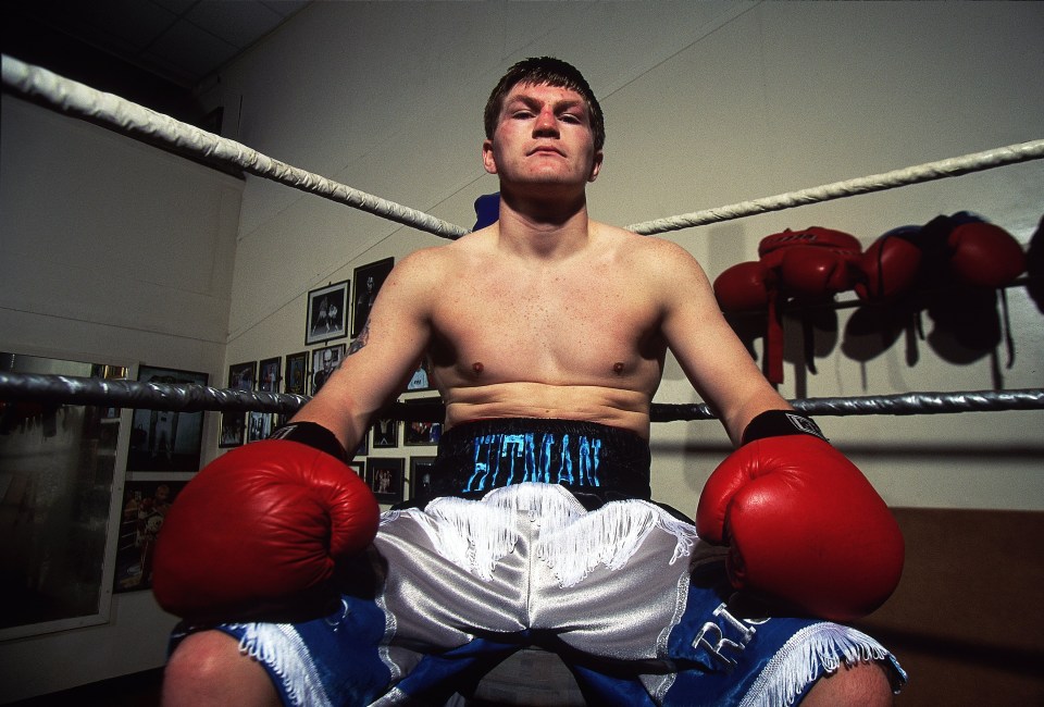 Ricky Hatton in boxing ring, wearing red gloves.