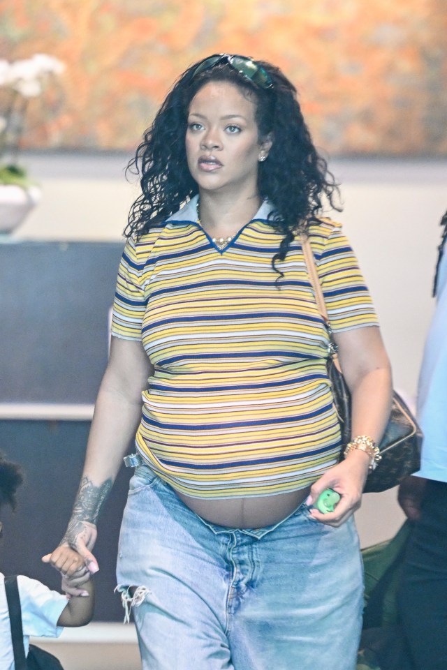 Rihanna in Los Angeles showing her baby bump while holding her son's hand.