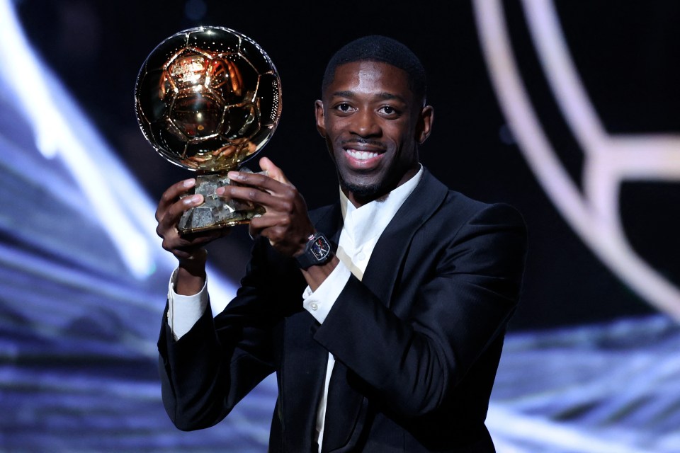Ousmane Dembele holding the Ballon d'Or award.