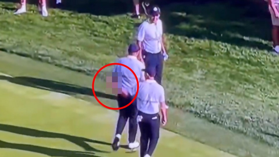 Man on a golf course with a finger exposed from the back of his pants.