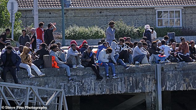 Large groups of mostly men were spotted idling at the notorious French people smuggling port of Gravelines near Calais on Friday