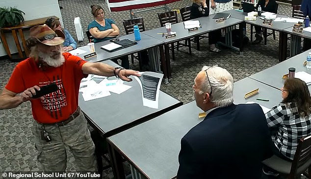 A school board meeting in Maine descended into chaos after Andrew Funaro, a school board board member (right) slapped a phone out of attendee Tim Bodnar's (left) hand