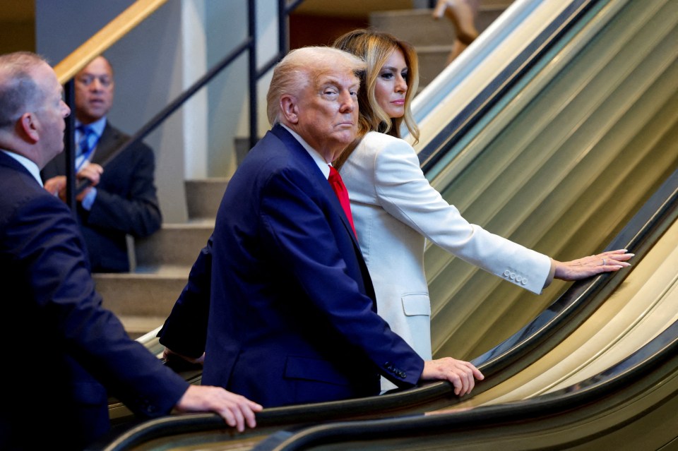 Donald Trump and Melania Trump ride an escalator at the United Nations General Assembly.