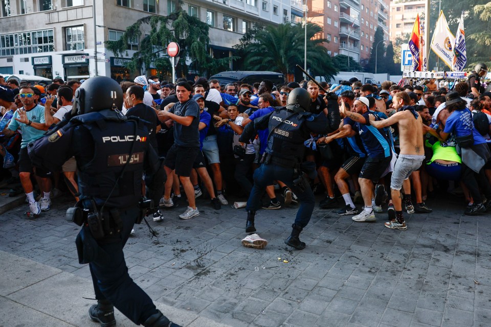Members of the Spanish national police clash with Olympique de Marseille supporters in Madrid.