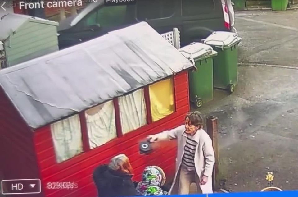 Security camera footage of a woman throwing boiling water on another woman.