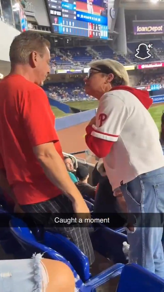 Woman yelling at man at a baseball game.