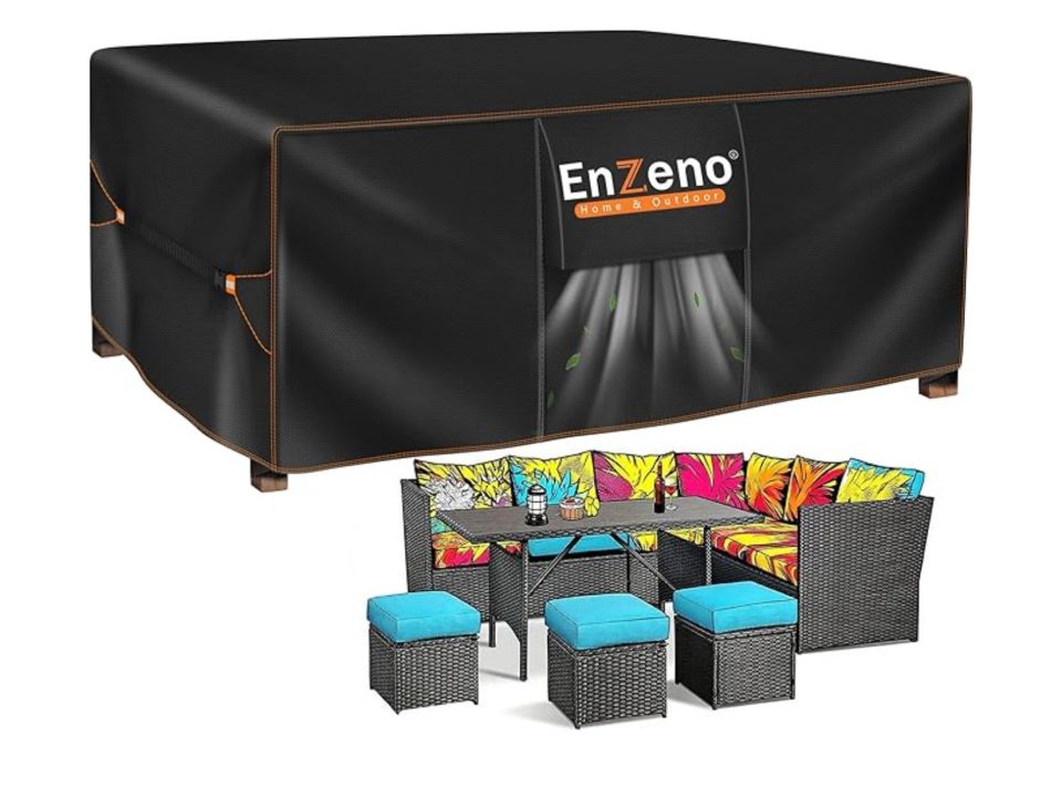 Black patio furniture cover and matching outdoor sectional with colorful cushions.