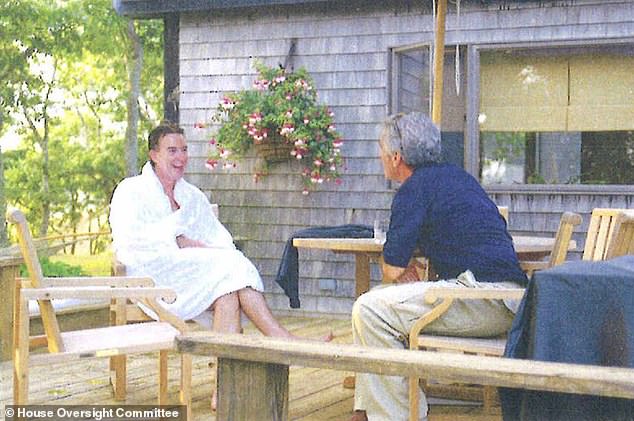 Lord Mandelson wears a white dressing gown as he chats with Jeffrey Epstein in around 2002