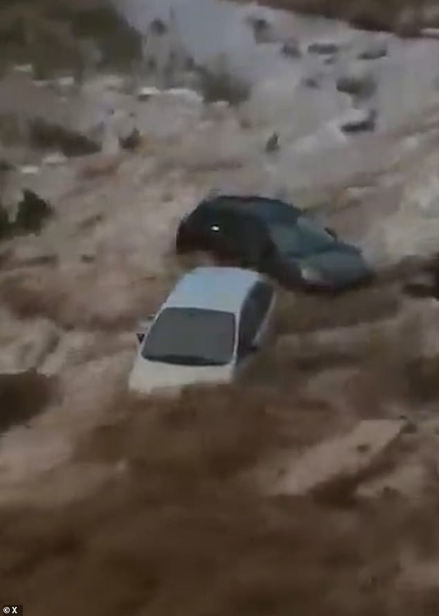 Drivers were filmed trapped inside their vehicles as surging waters surrounded them, forced to wait desperately for rescuers to arrive